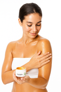 Woman applying turmeric cream 